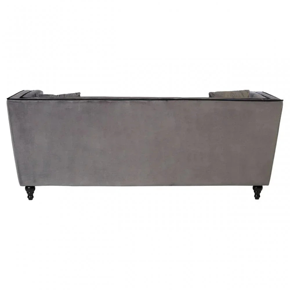 Rear view of grey velvet sofa with black wooden legs and straight back design