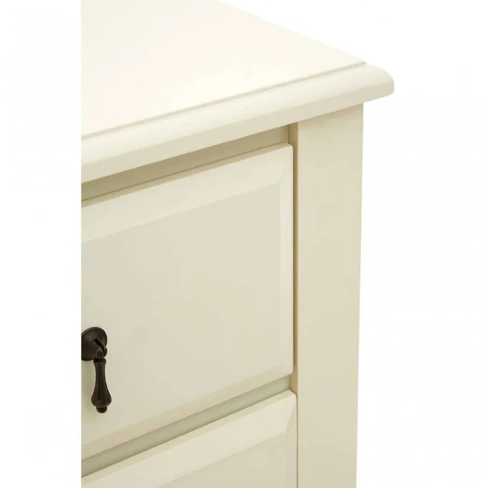 Cream wood chest of drawers corner showing smooth finish and metal drawer handle