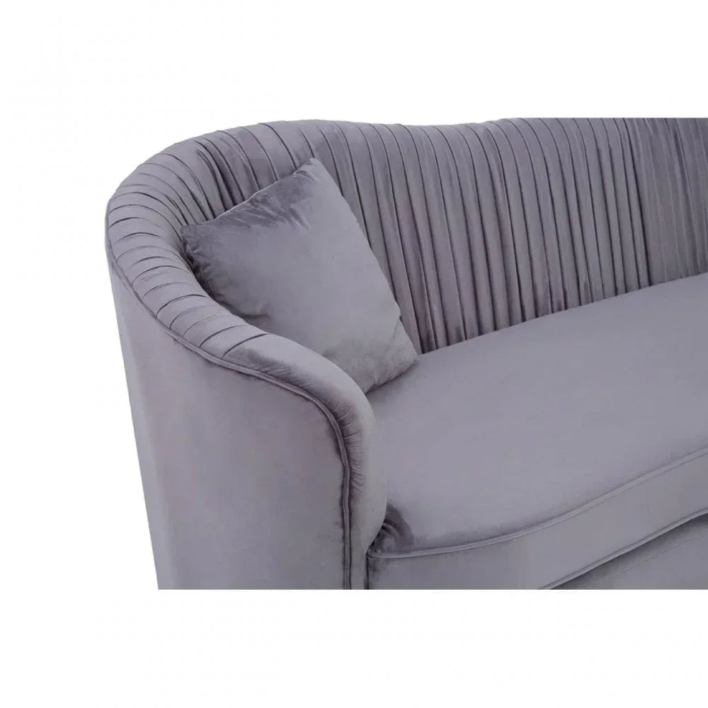 Grey velvet sofa with pleated backrest and matching cushion, partial side view
