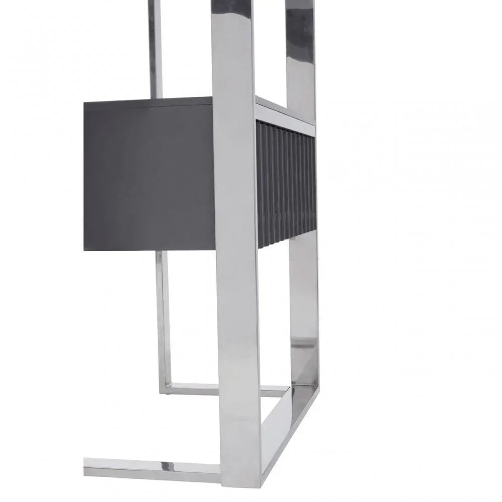 Closeup of modern console table with chrome legs and black ribbed panel detail