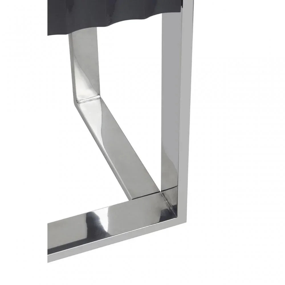 Polished chrome dining table leg with modern geometric design and reflective finish
