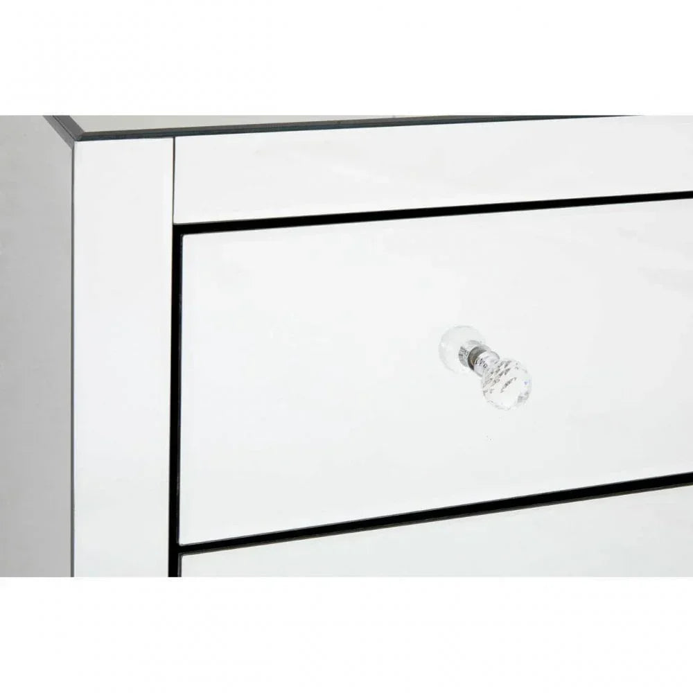 Close-up of mirrored chest of drawers with glass knob handle