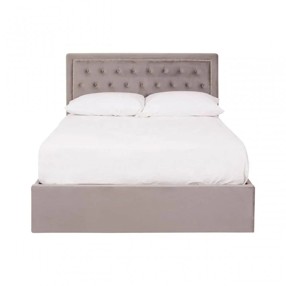 Grey upholstered bed frame with button-tufted headboard and white bedding, front view