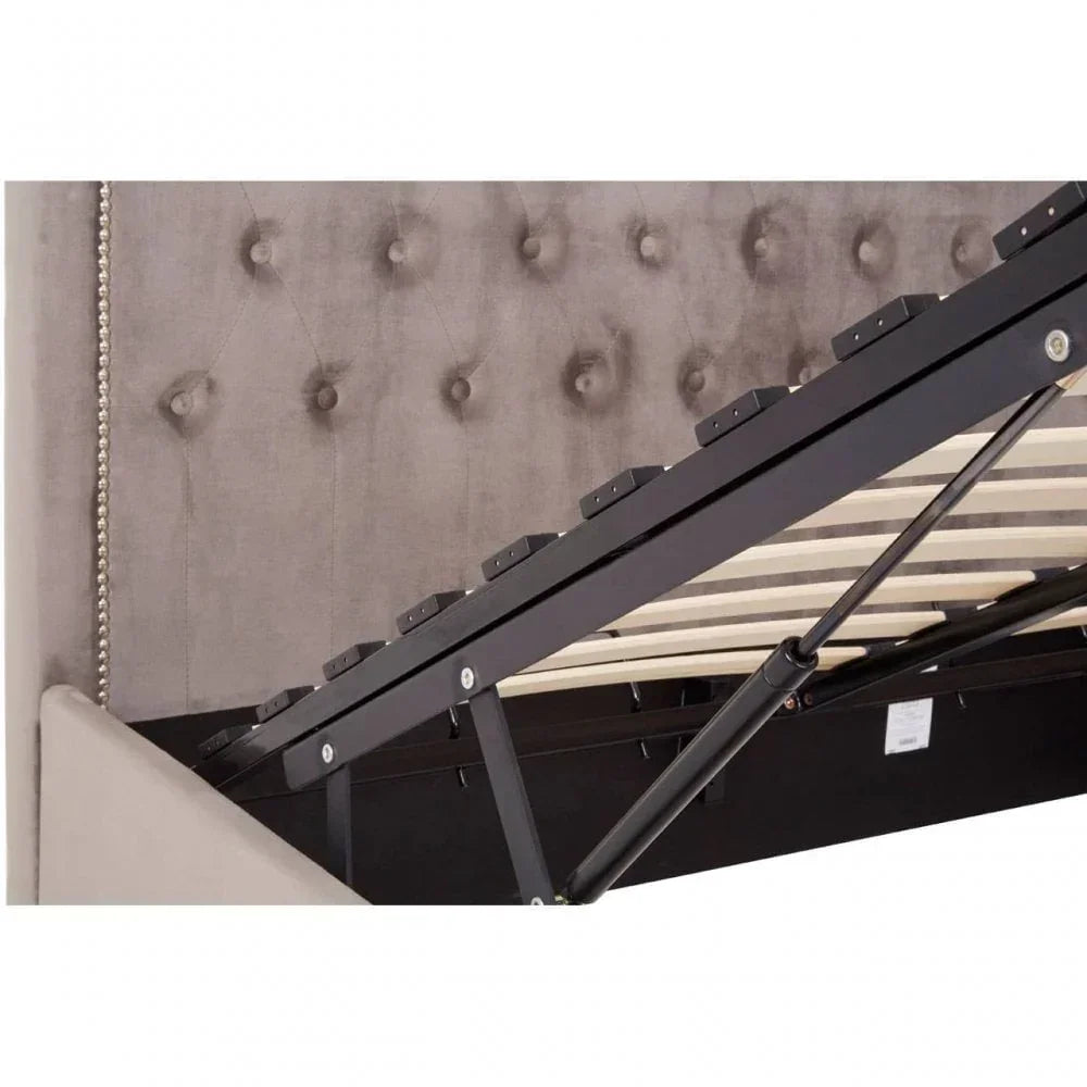 Grey upholstered ottoman bed lifted to show storage space and slatted frame mechanism