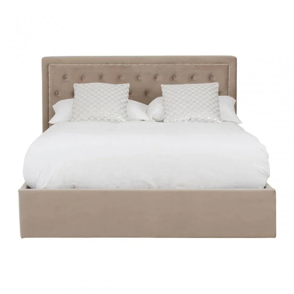 Beige upholstered bed frame with button-tufted headboard and white bedding, front view