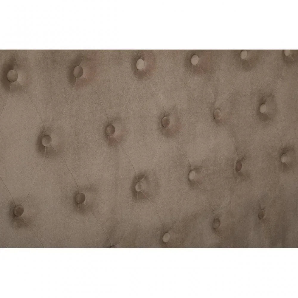 Close-up of taupe velvet upholstered headboard with button tufting