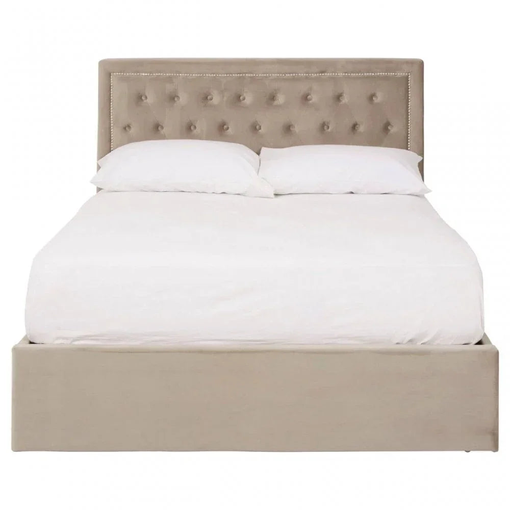 Beige upholstered bed frame with tufted headboard and white bedding front view