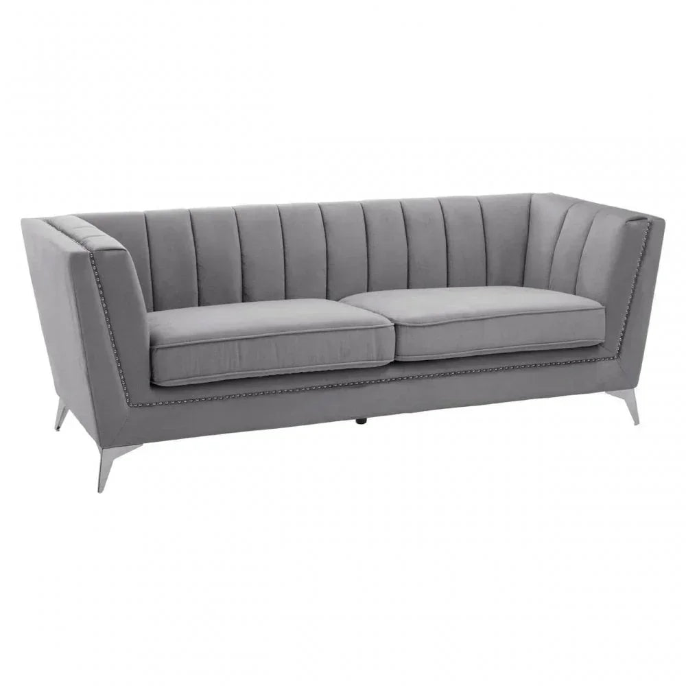 Grey velvet sofa with channel tufted back, nailhead trim and angled metal legs