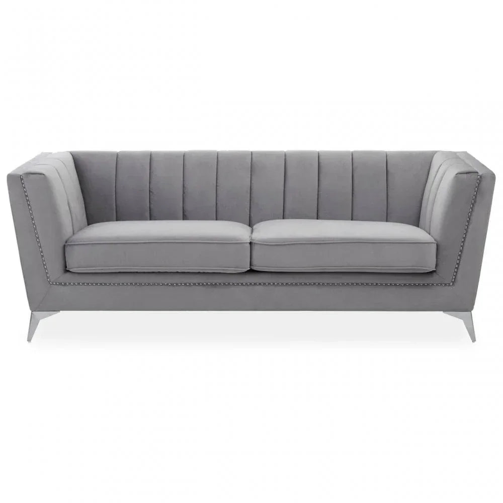 Grey velvet sofa with channel tufted back and studded trim, metal legs, front view