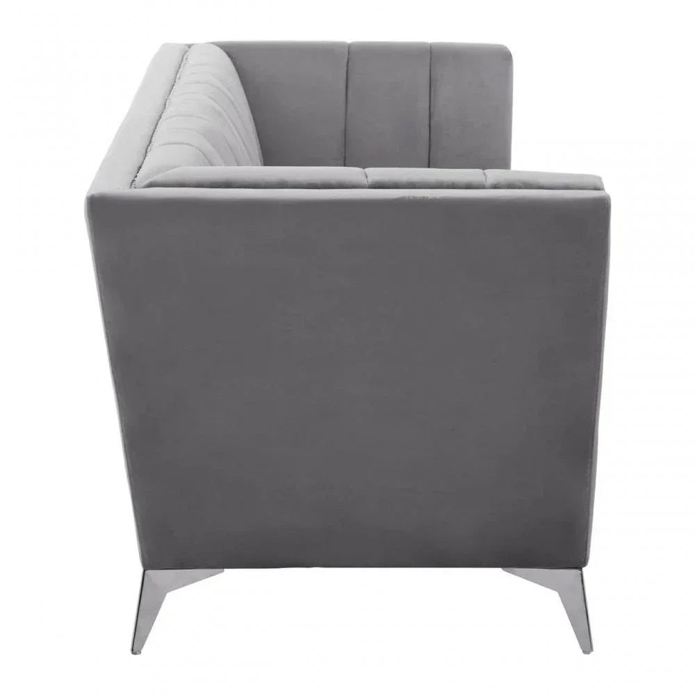 Grey velvet sofa with vertical stitched backrest, side view on metal legs