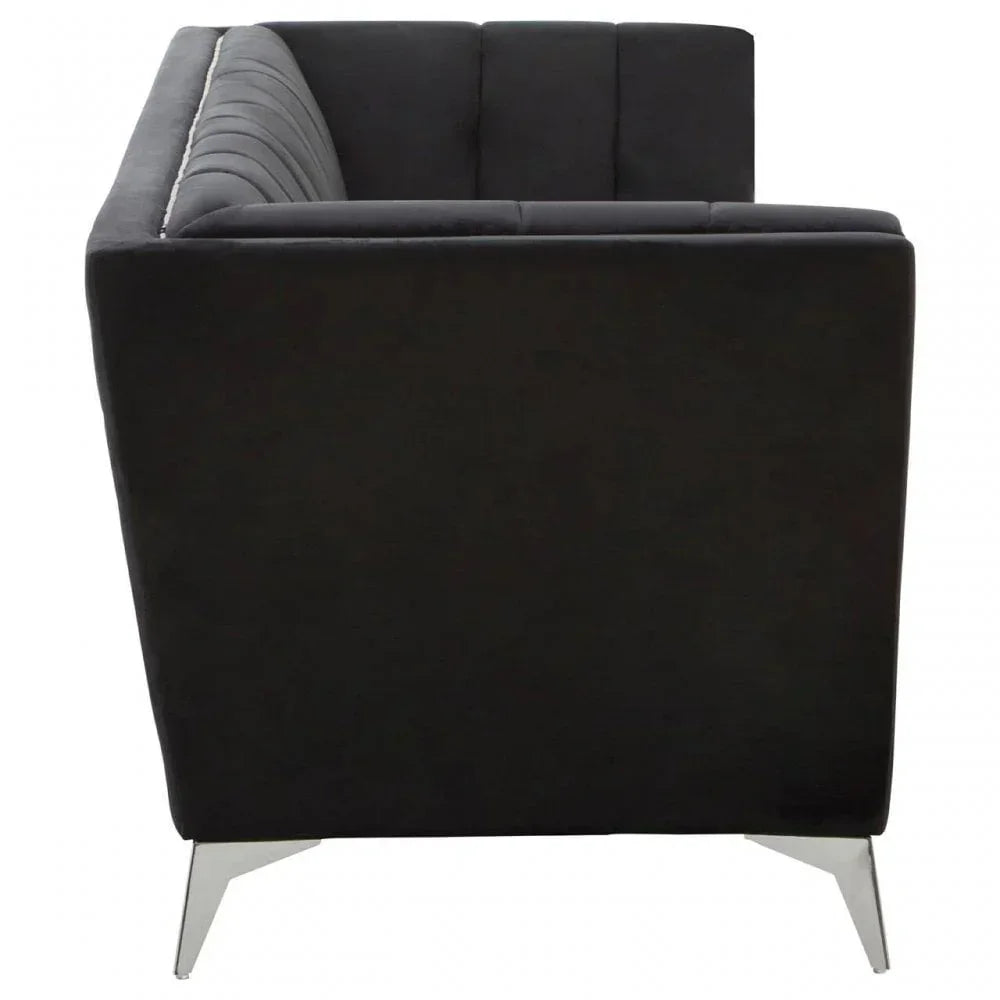 Black velvet sofa side view with chrome legs and vertical channel backrest