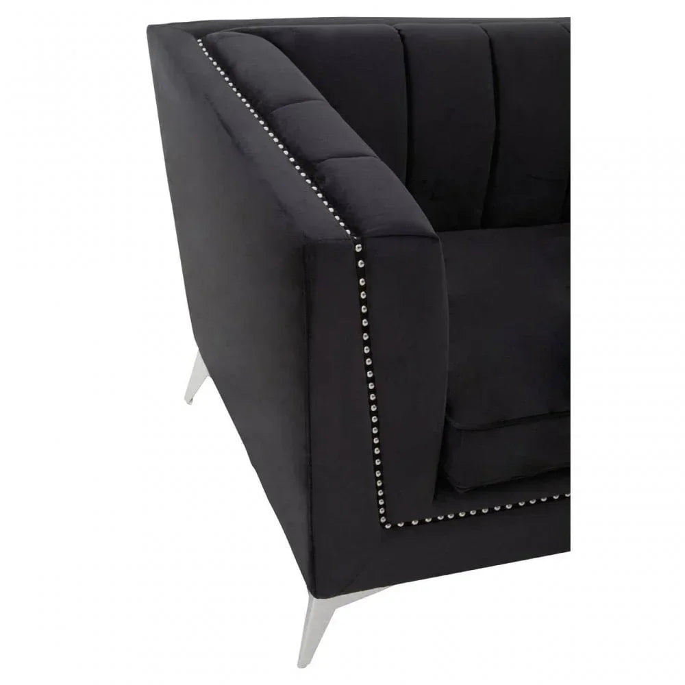 Black velvet sofa corner with silver stud trim and chrome legs