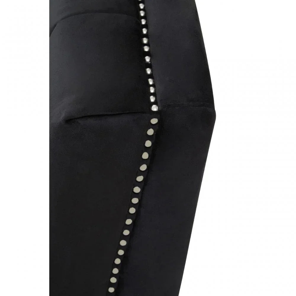 Black fabric sofa armrest with silver stud detailing close-up