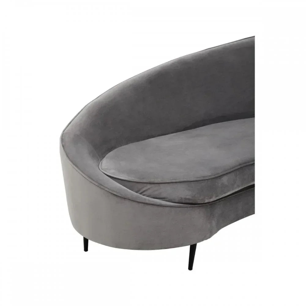 Curved grey velvet sofa with black legs, close-up of seat and armrest