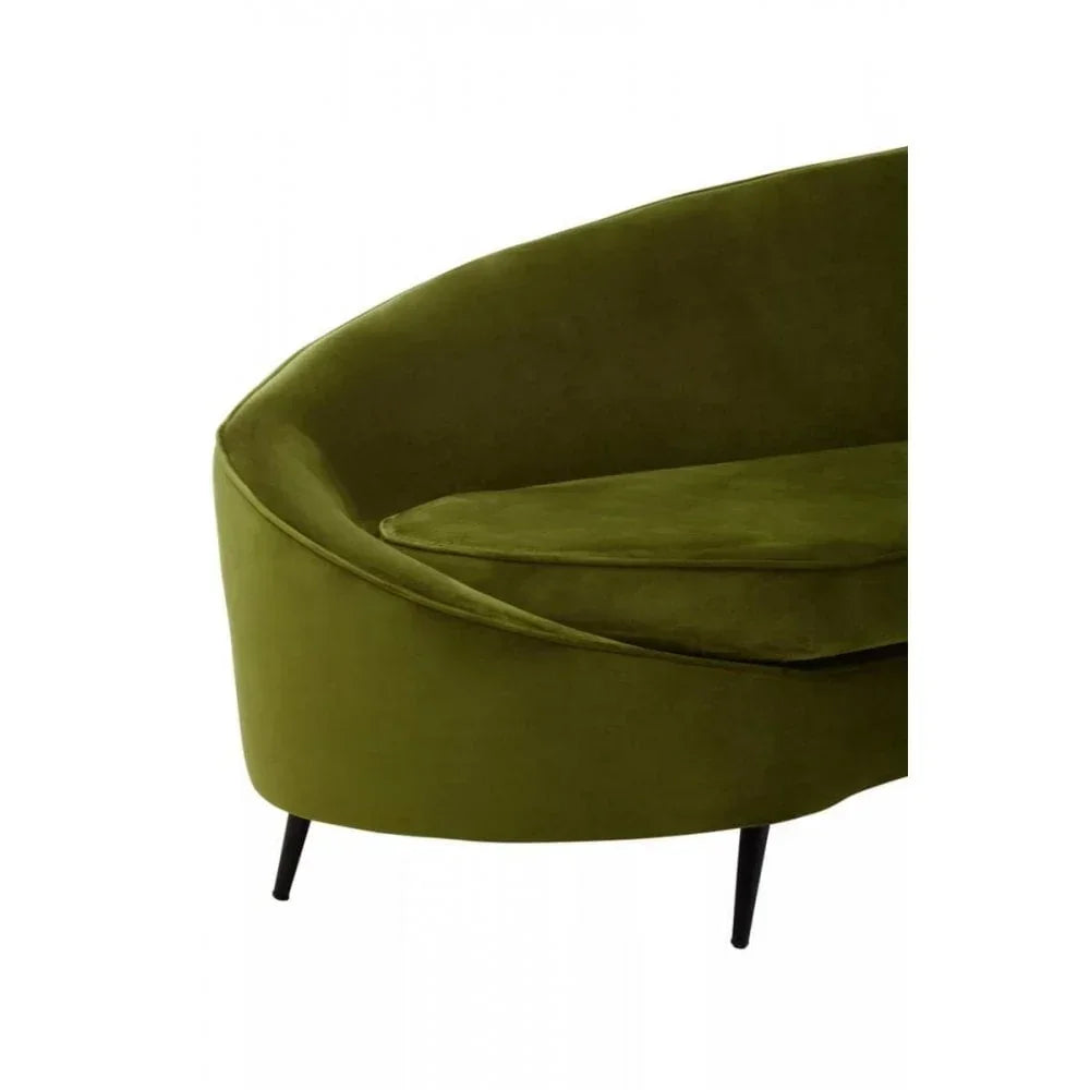 Olive green velvet sofa with black metal legs, close-up of curved seat and cushion