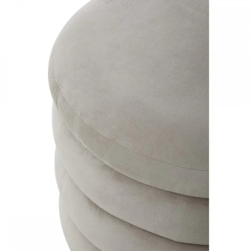 Close view of beige velvet round ottoman with stitched detail
