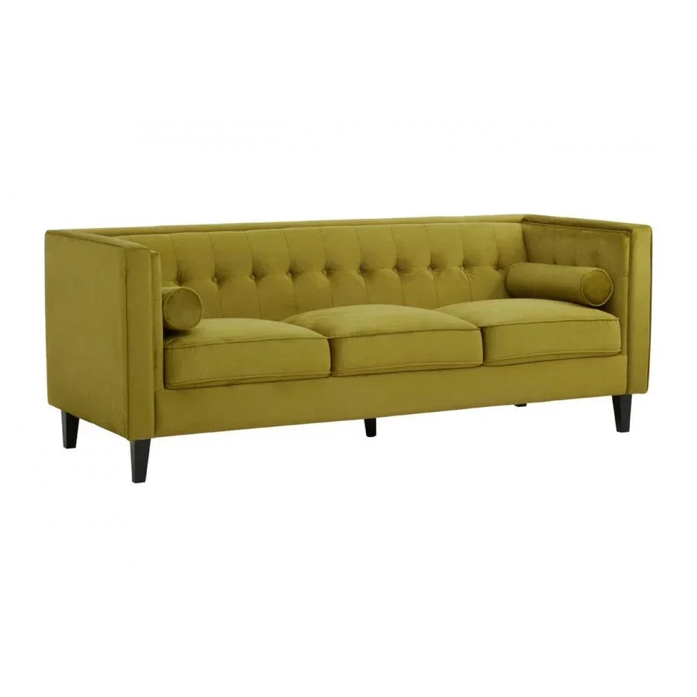 Olive green velvet sofa with tufted back, three seat cushions, black legs, and bolster pillows