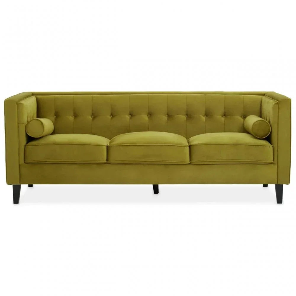 Green velvet sofa with button-tufted backrest, three seat cushions and bolster pillows