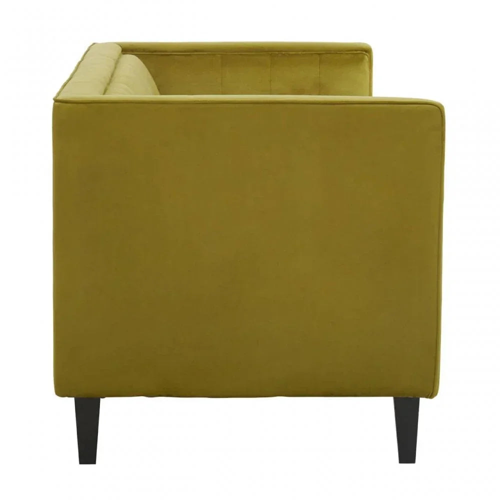 Side view of green velvet sofa with square arms and tapered black legs