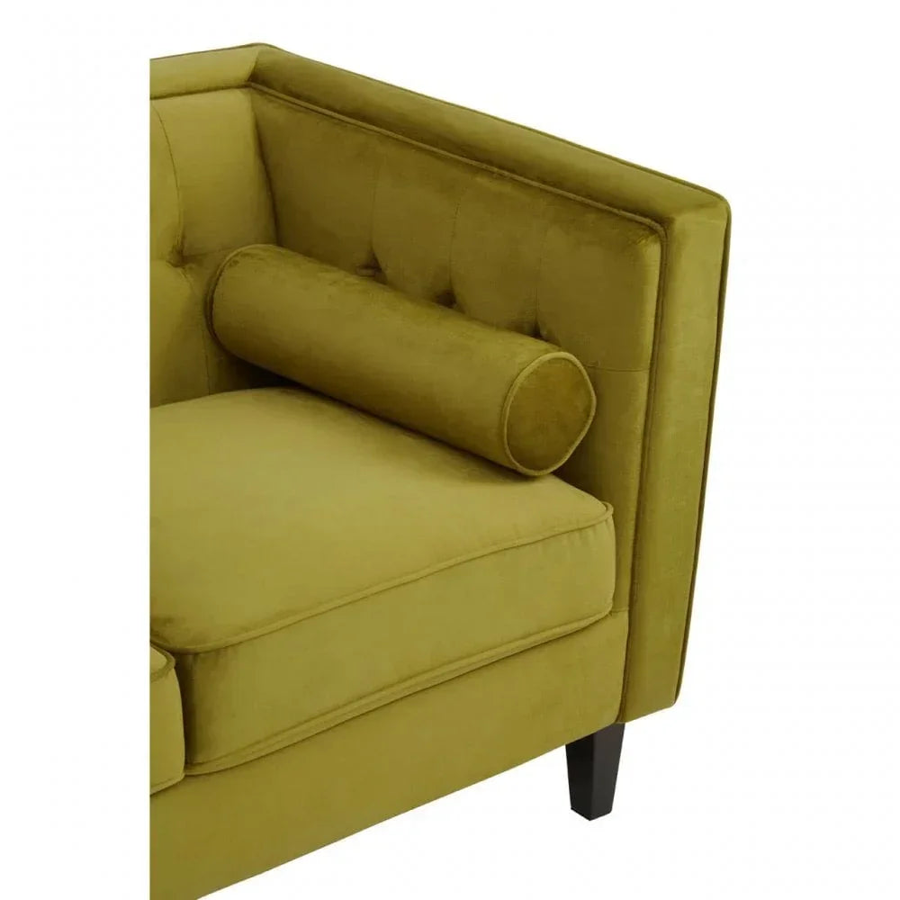 Olive green velvet corner sofa with tufted back and matching bolster cushion