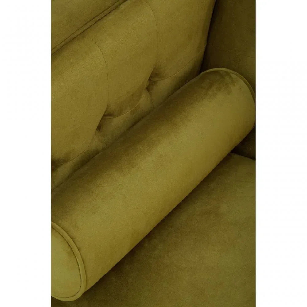 Close-up of olive green velvet sofa armrest with tufted backrest detail