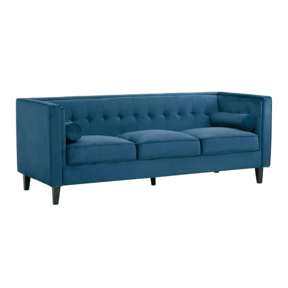 Blue velvet sofa with tufted back, three seat cushions, and two bolster pillows, front angle