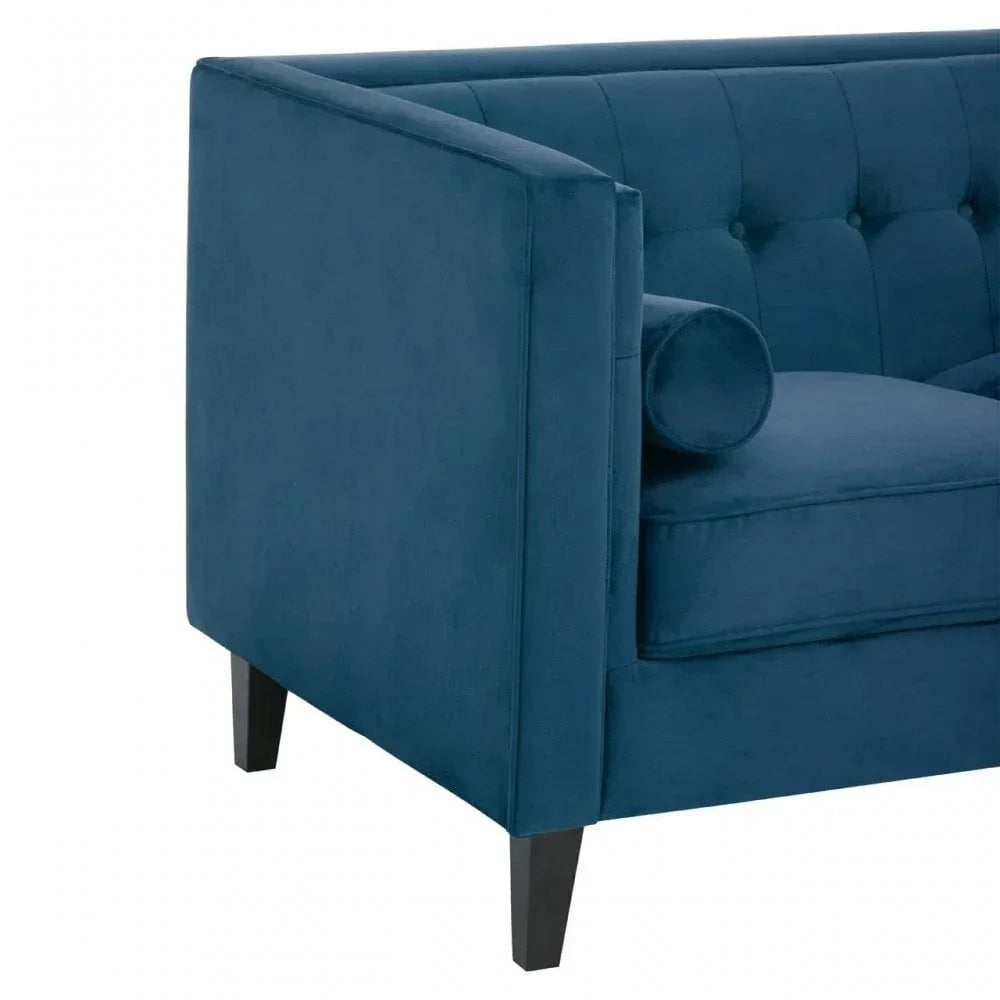 Blue velvet sofa corner with buttoned back and slim black legs