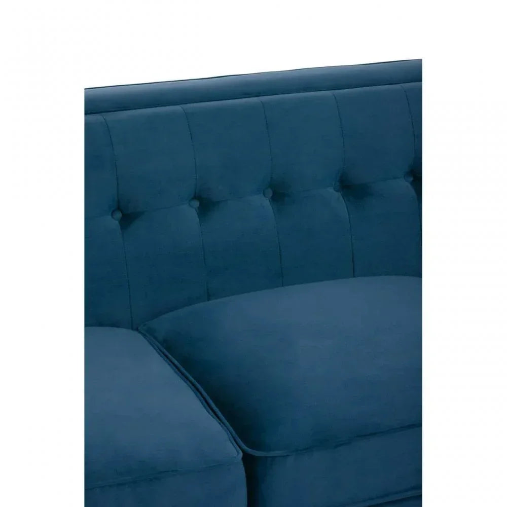 Blue fabric sofa with tufted backrest and plush seat cushions close-up view