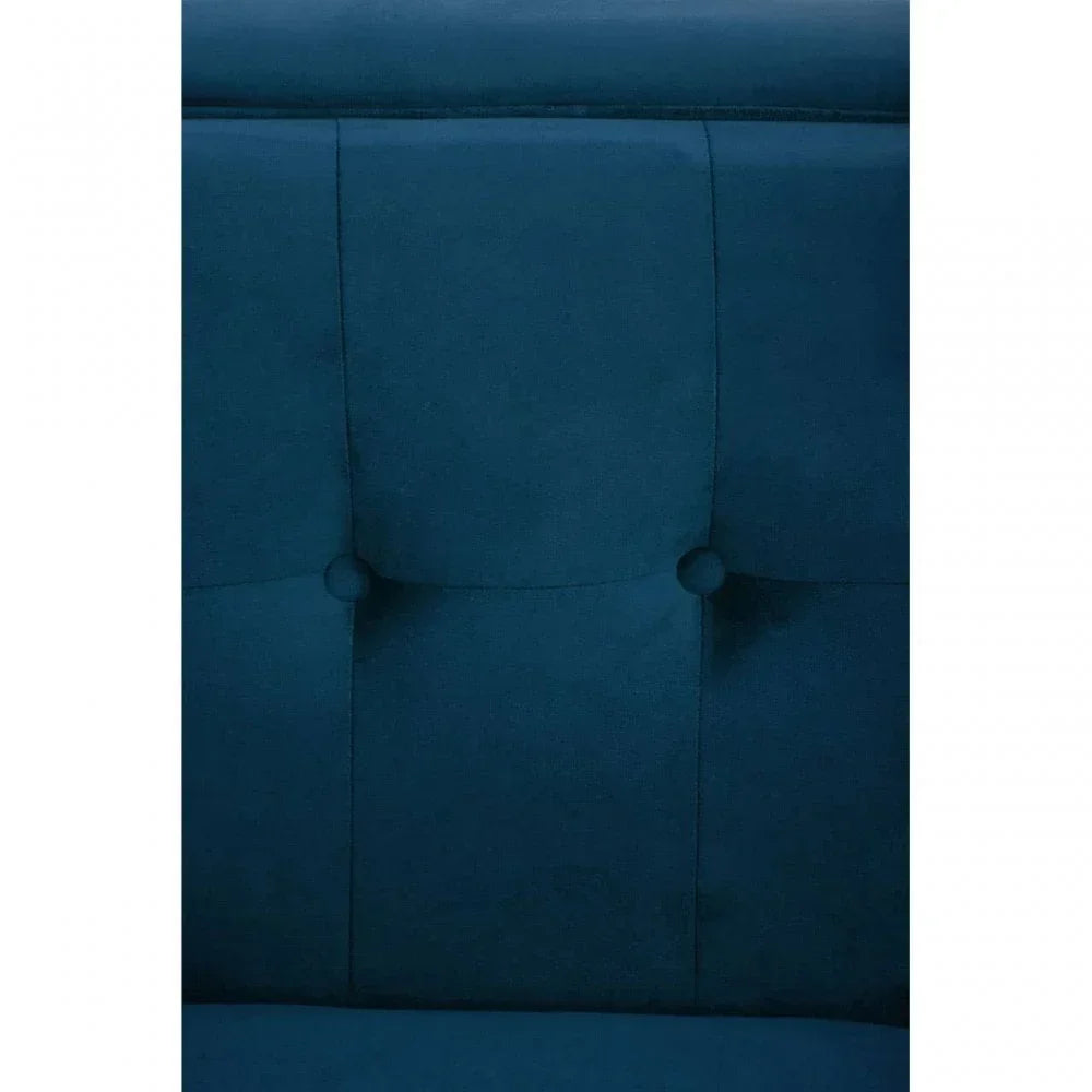 Close up of blue velvet upholstered bed headboard with button tufted detail