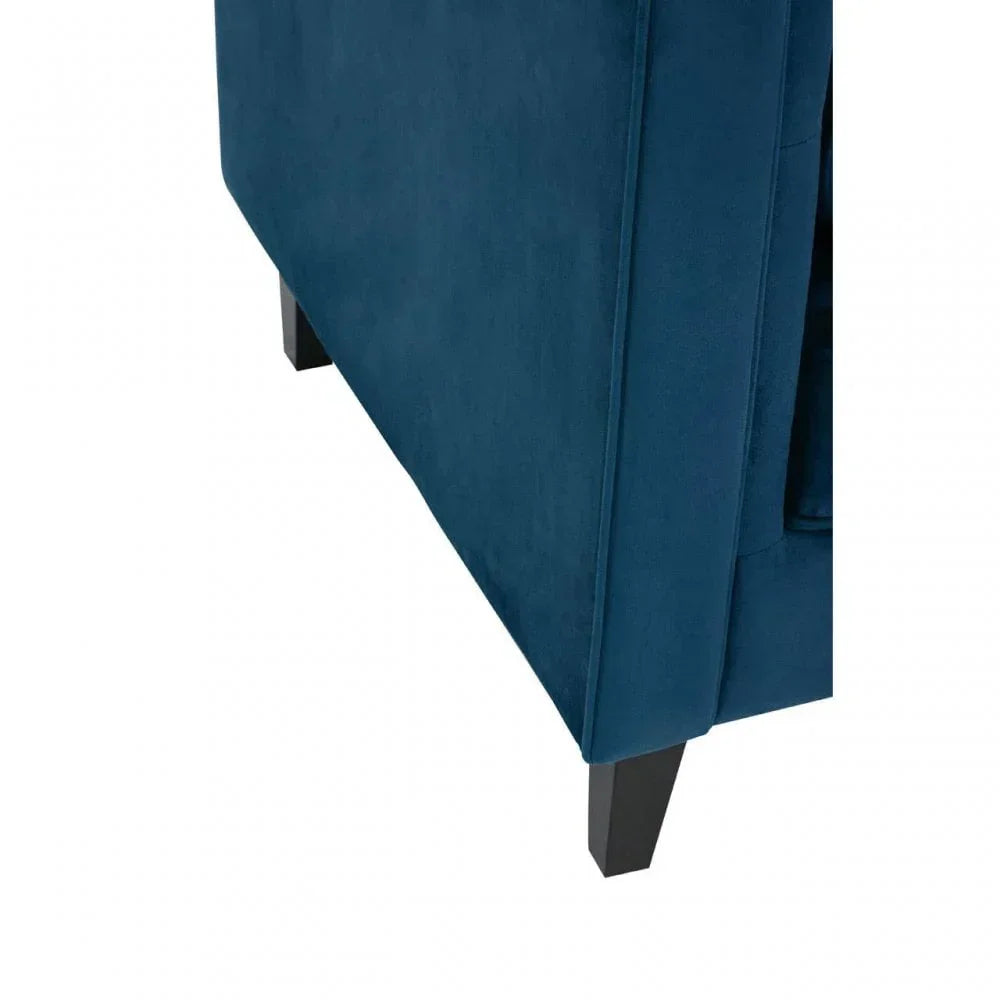 Close-up of dark blue fabric sofa corner with wooden legs