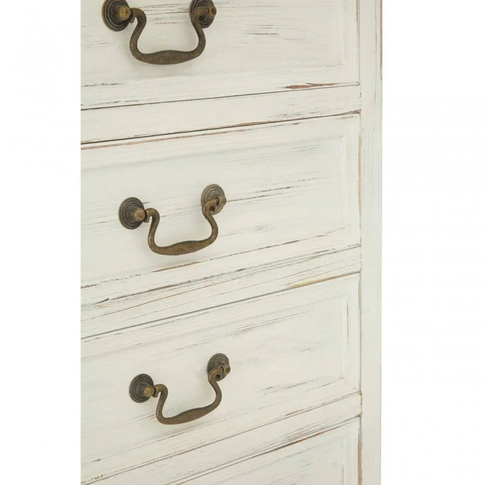 Distressed white chest of drawers with antique brass handles, close-up view