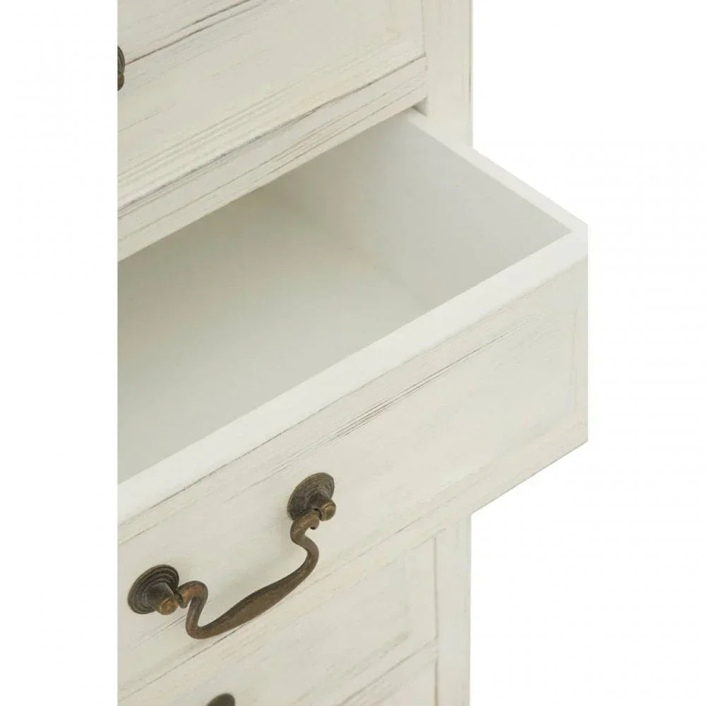Close-up of white wooden chest of drawers with antique brass handle and open drawer