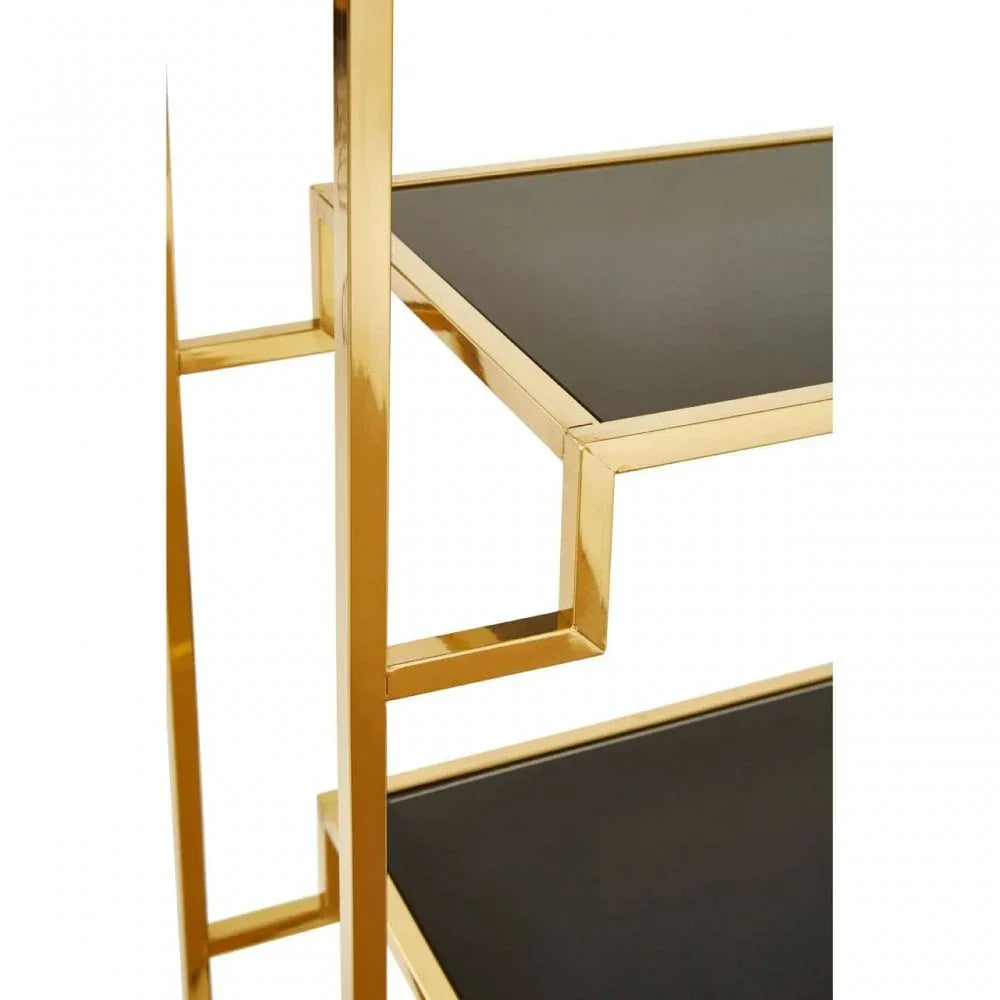 Gold metal shelving unit with black glass shelves, side angle view