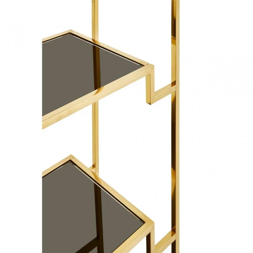 Gold metal shelving unit with black glass shelves, modern design detail close-up