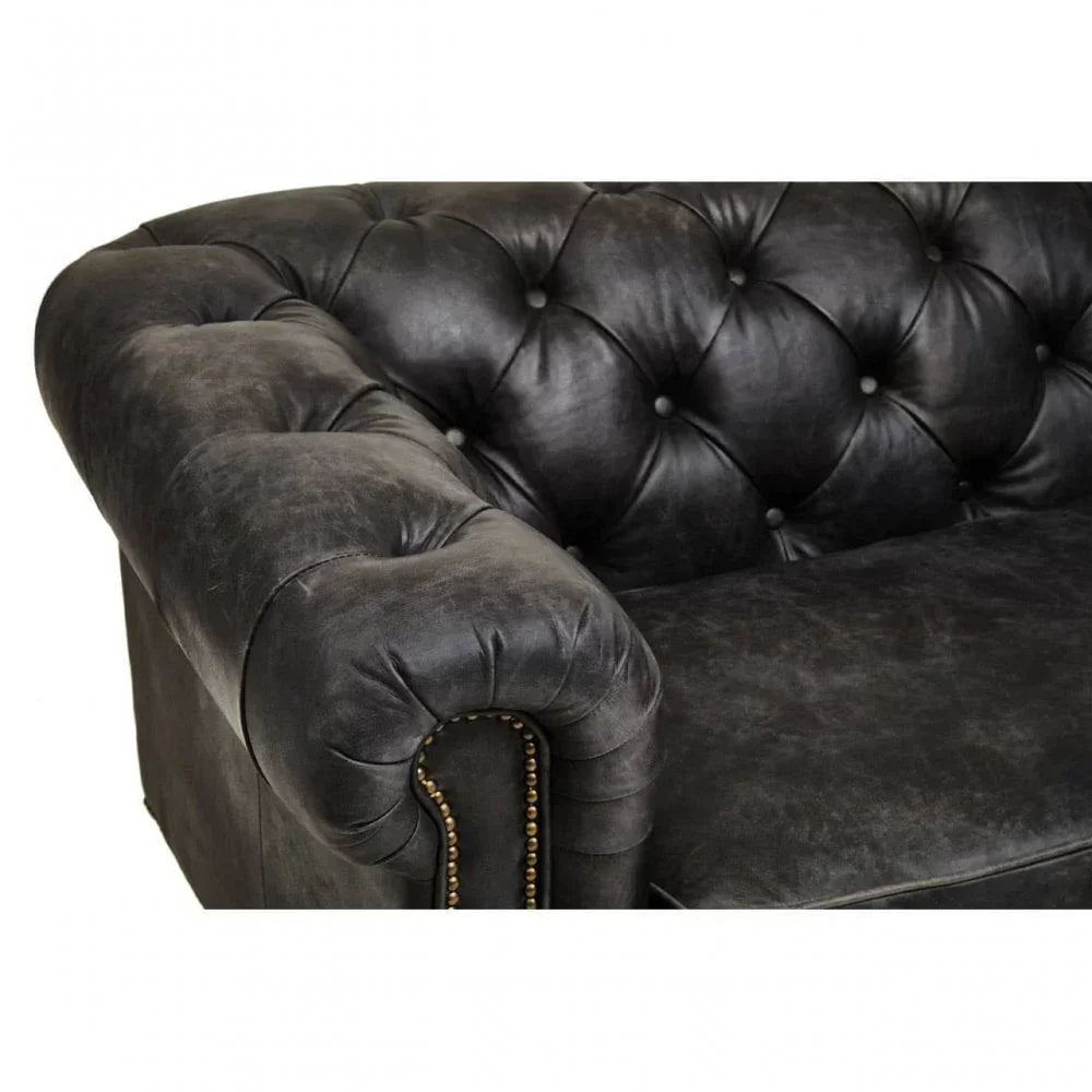 Black leather Chesterfield sofa with tufted back and armrest detail