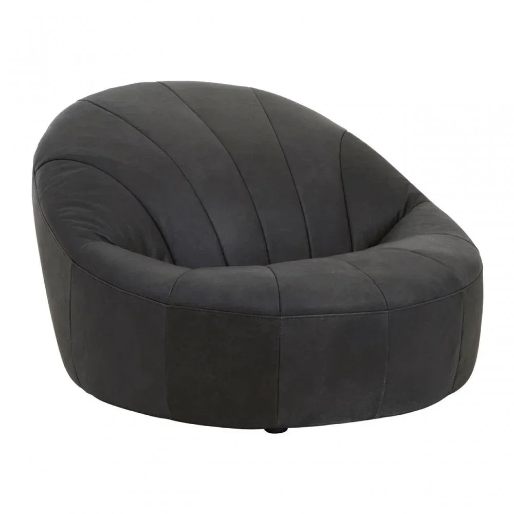 Black velvet accent chair with rounded backrest and stitched panel detailing