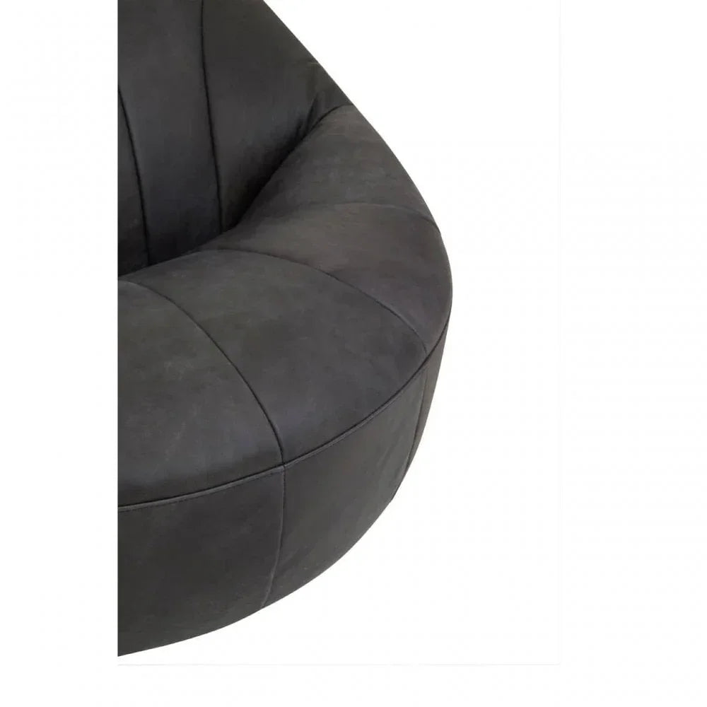 Close view of dark grey fabric armchair upholstery and curved seat design
