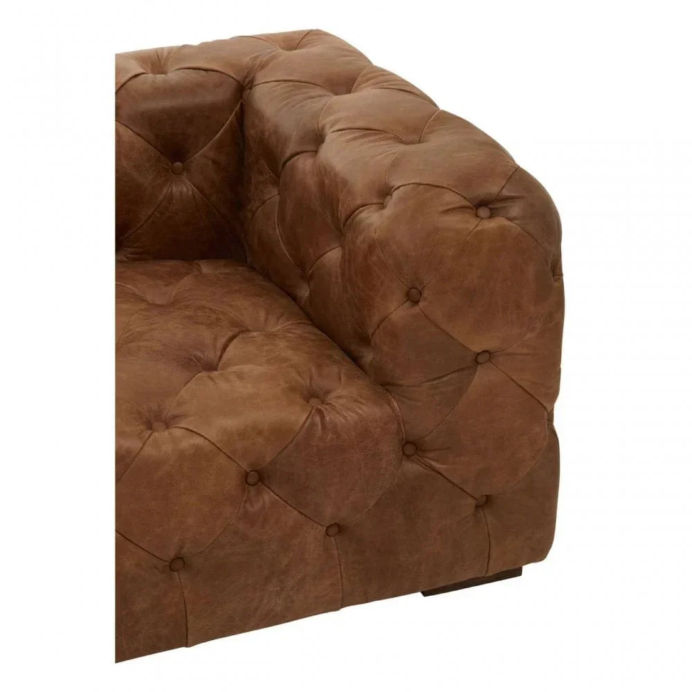 Brown leather Chesterfield sofa corner with deep button tufting and rolled arm