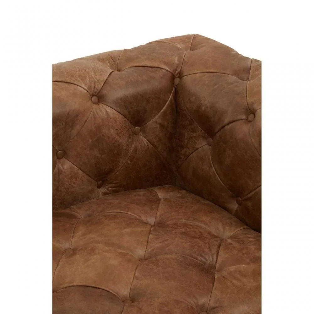 Close-up of brown leather Chesterfield sofa with deep button tufting