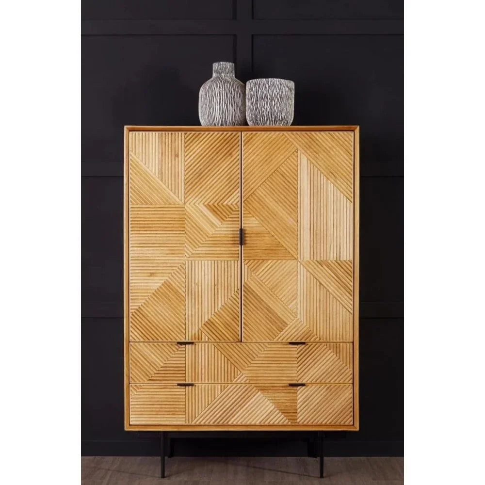 Geometric wood cabinet with four drawers and two doors, black legs, two decorative vases on top