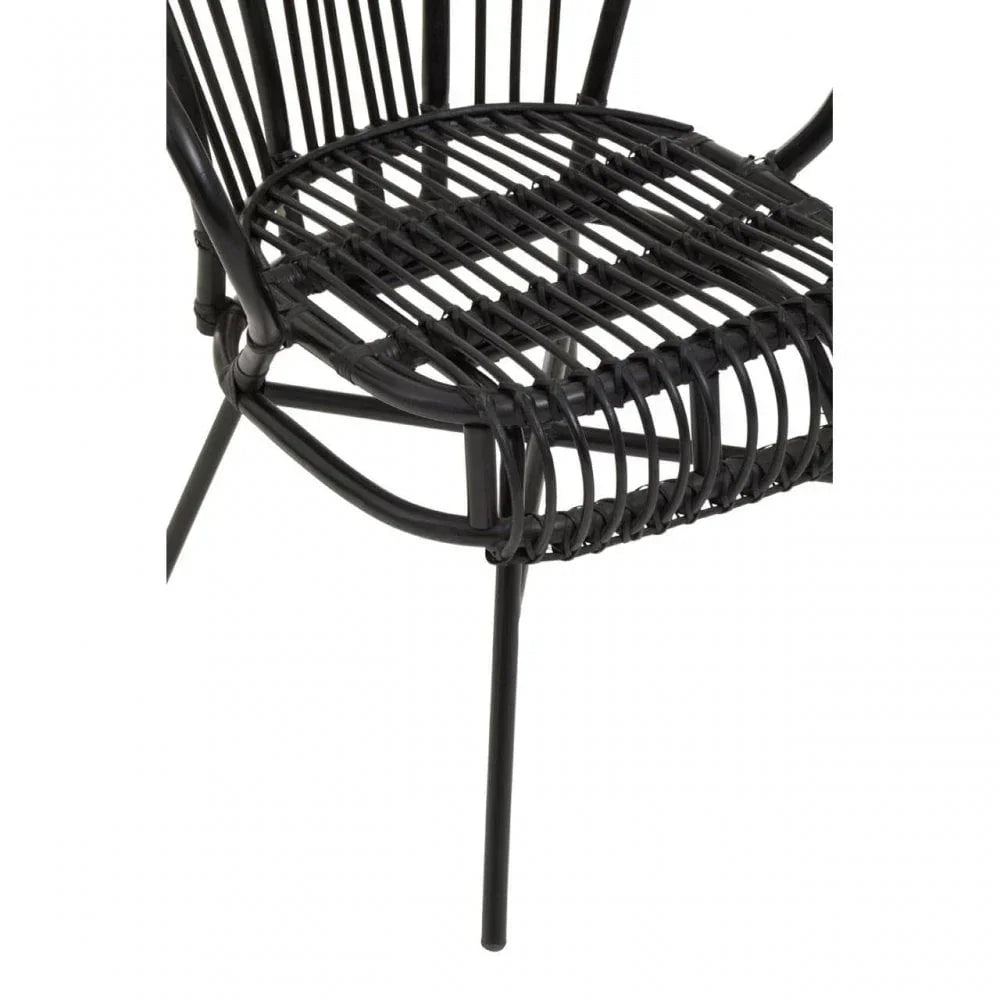 Black rattan dining chair with metal legs, close view of woven seat and frame