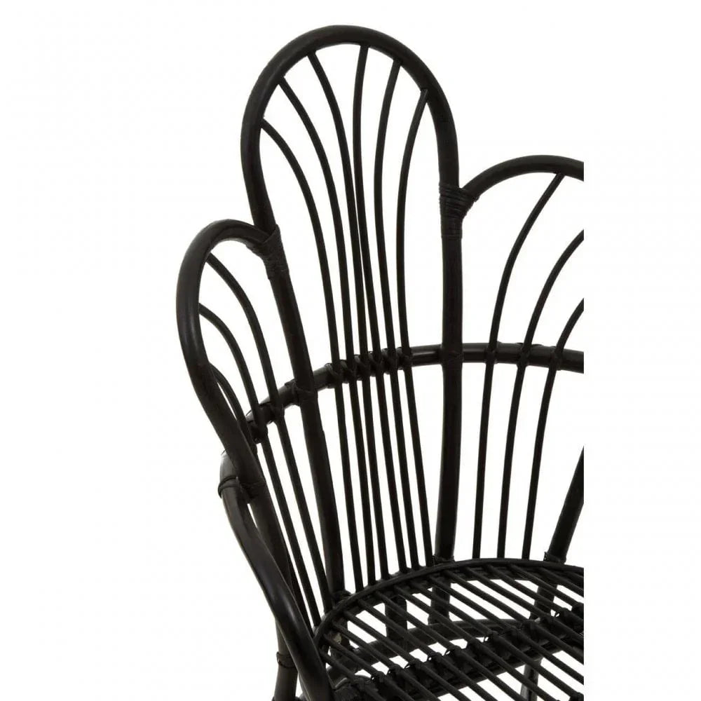 Black rattan chair with curved backrest and openwork design, close-up view