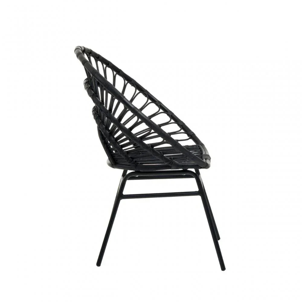 Black rattan chair with open weave design and metal legs, side view