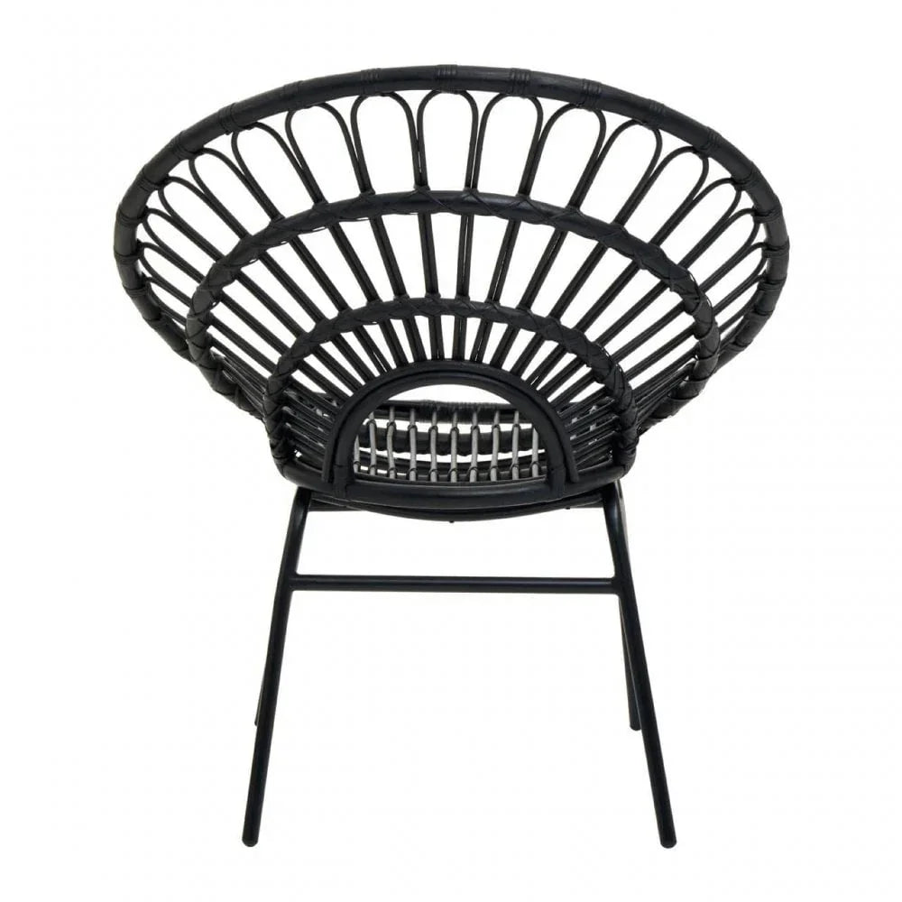 Black rattan accent chair with circular woven backrest and metal legs, rear angle view