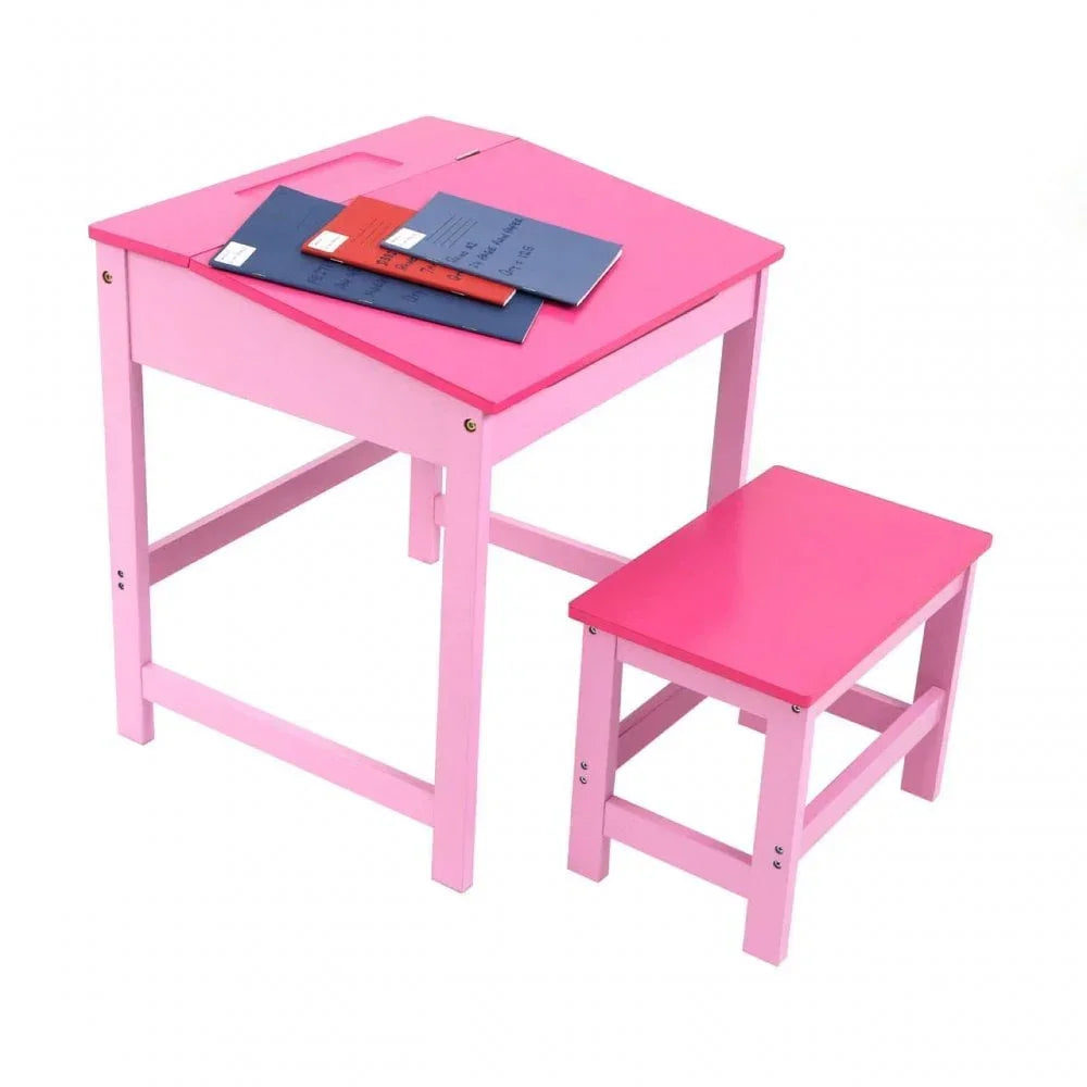 Pink wooden kids desk and matching stool with notebooks on slanted desktop