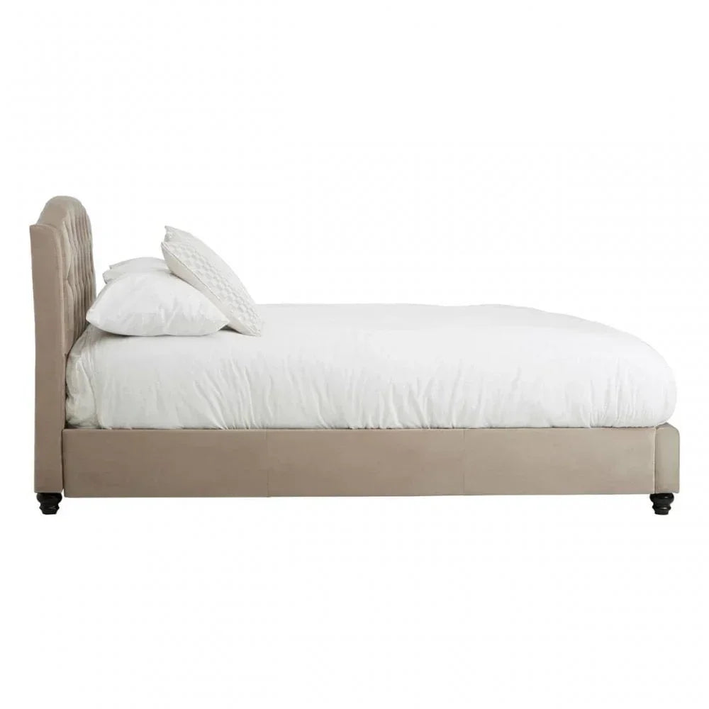 Beige upholstered bed frame with white bedding and matching pillows side profile view