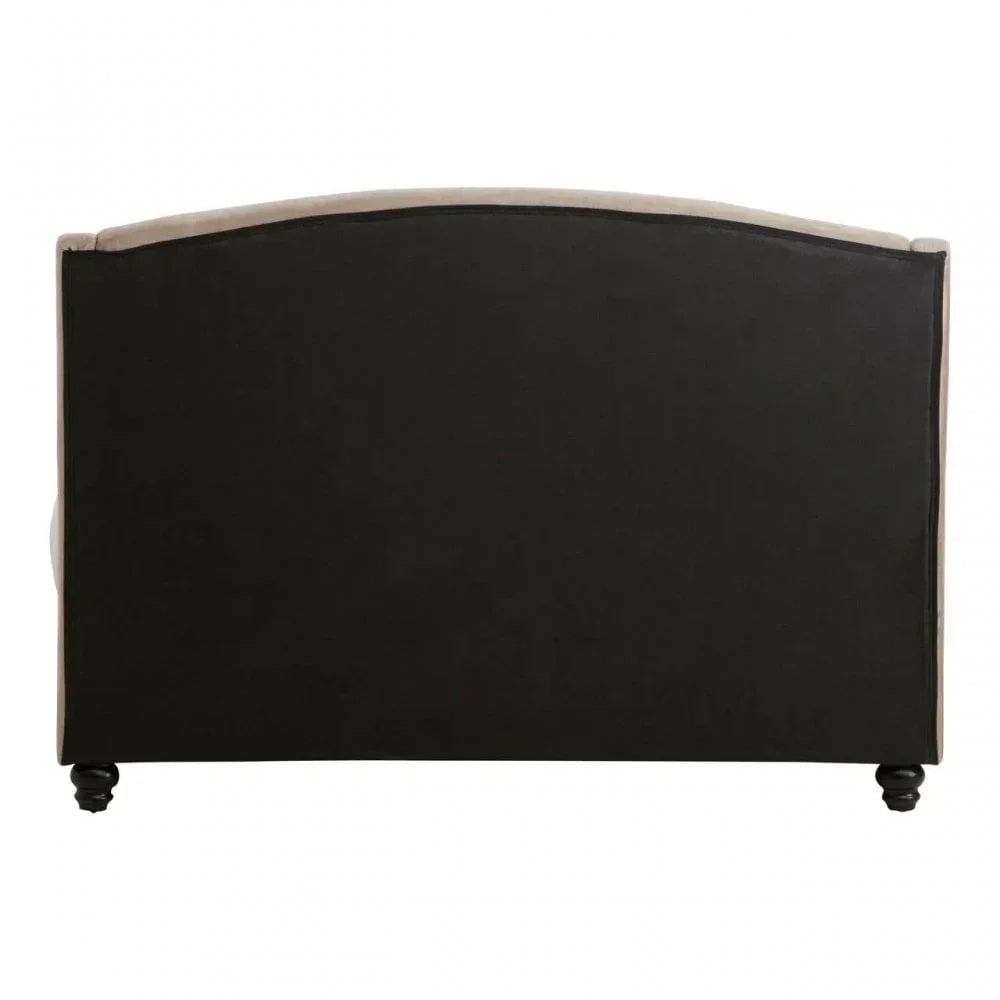 Rear view of upholstered sofa with black fabric back and wooden feet