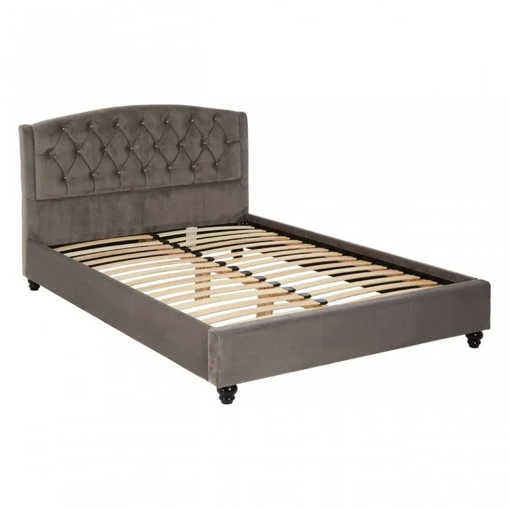Grey upholstered bed frame with tufted headboard and wooden slats