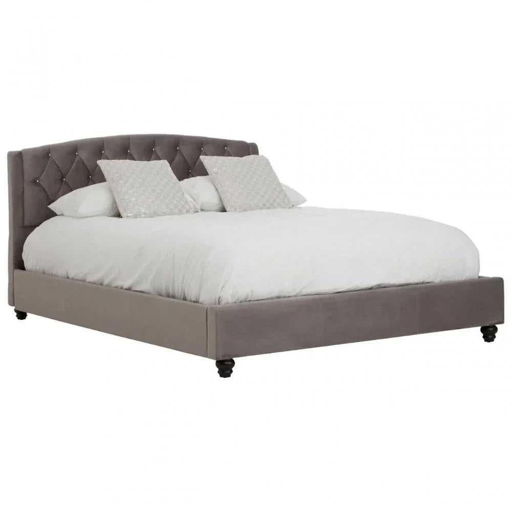 Grey upholstered bed frame with tufted headboard, white bedding and decorative pillows