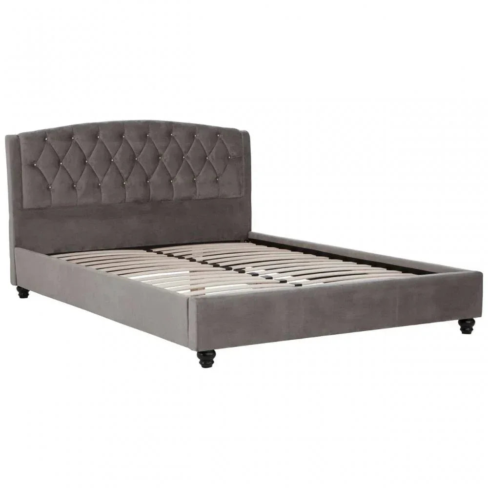 Grey upholstered bed frame with diamond tufted headboard and wooden slats, angled view